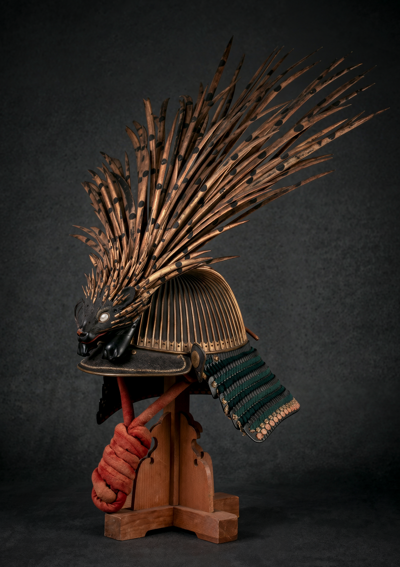 Japanese samurai kabuto helmet with an elaborate spiked animal crest and green-laced shikoro neck guard